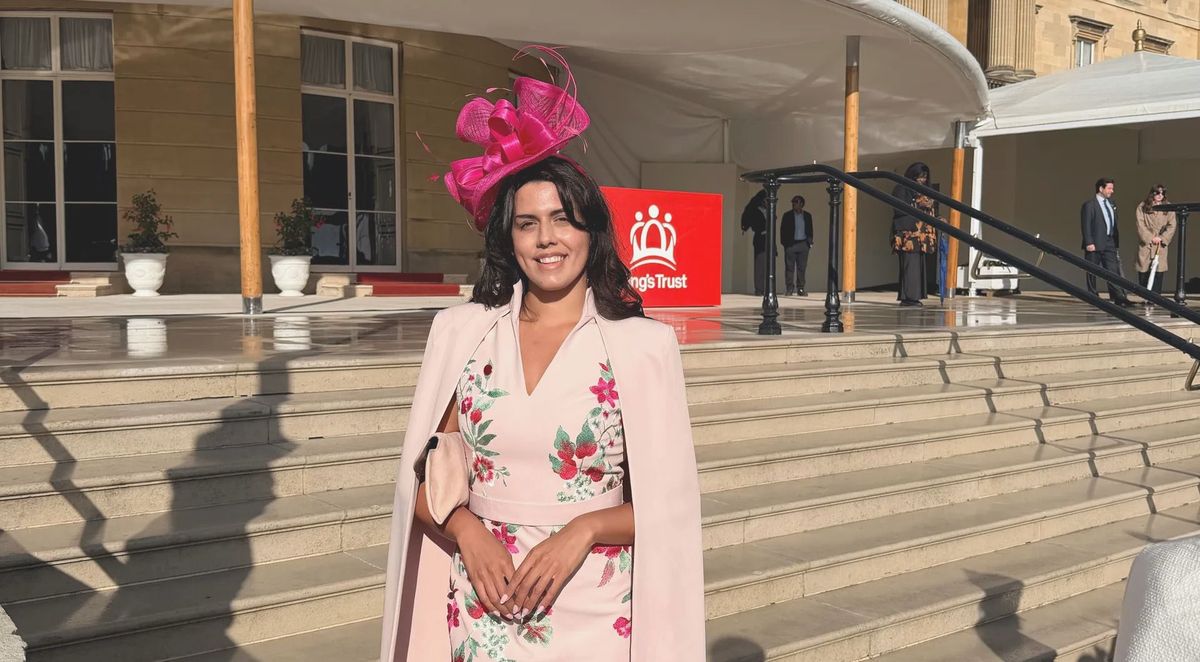 Emma Rego in a pink floral outfit and fuchsia hat on the steps at Buckingham Palace, REGO Creative journal