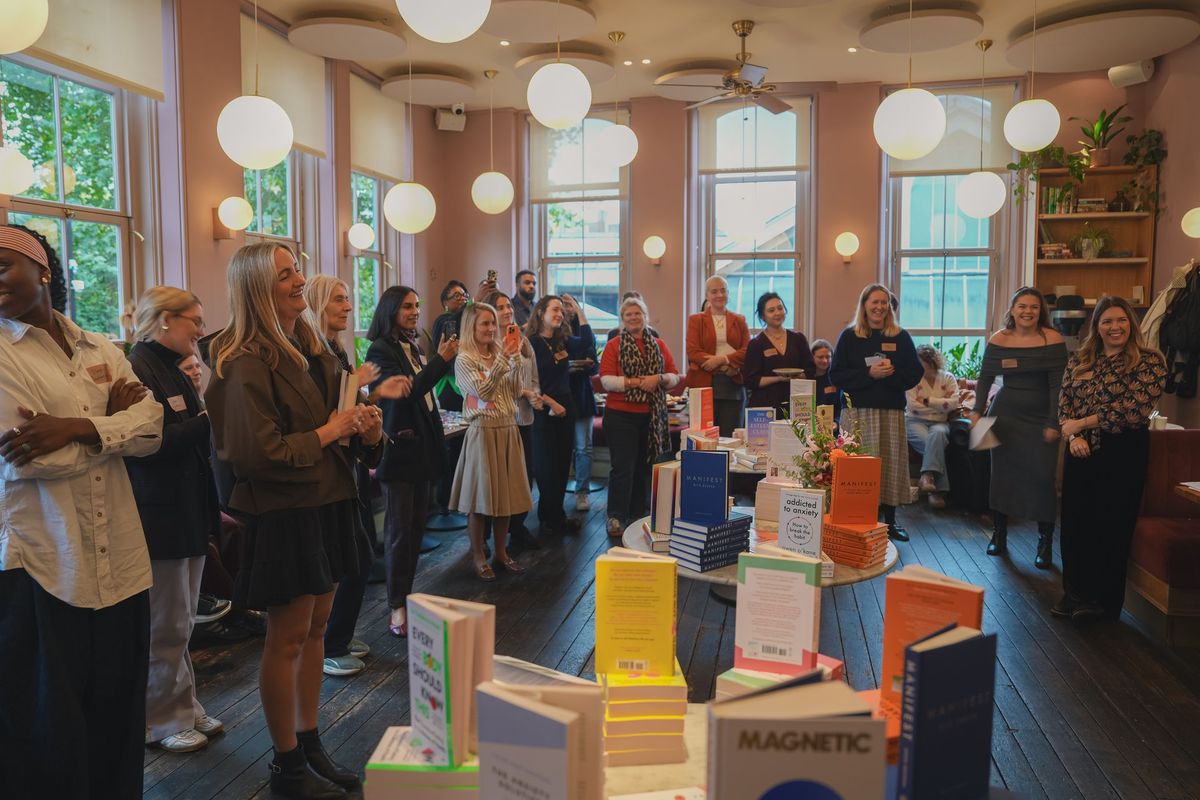 Guests gathered around book tables at the Coral Press launch event in London, by REGO Creative