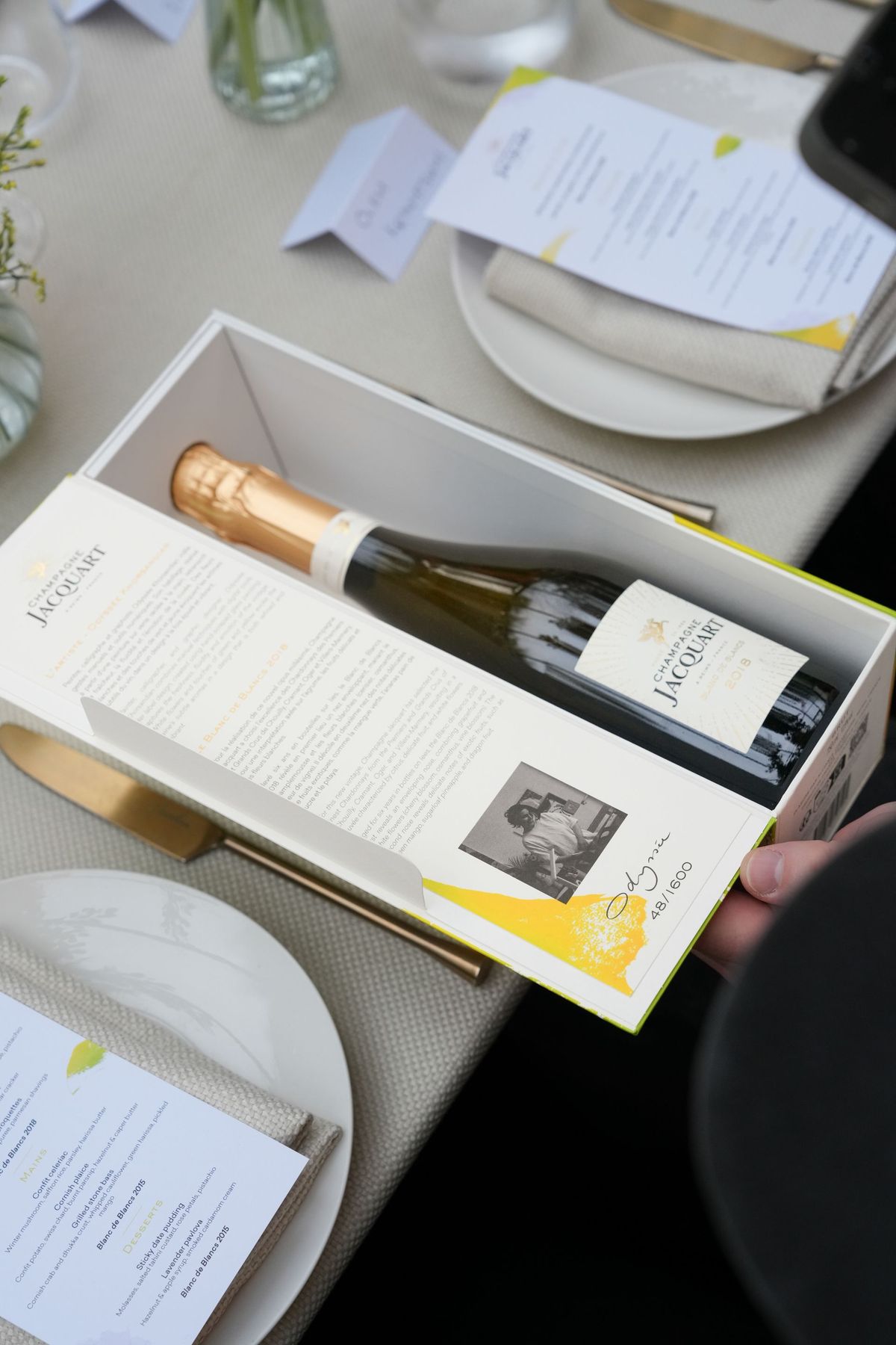 Champagne Jacquart limited edition gift box opened to show the bottle and artist note, by REGO Creative