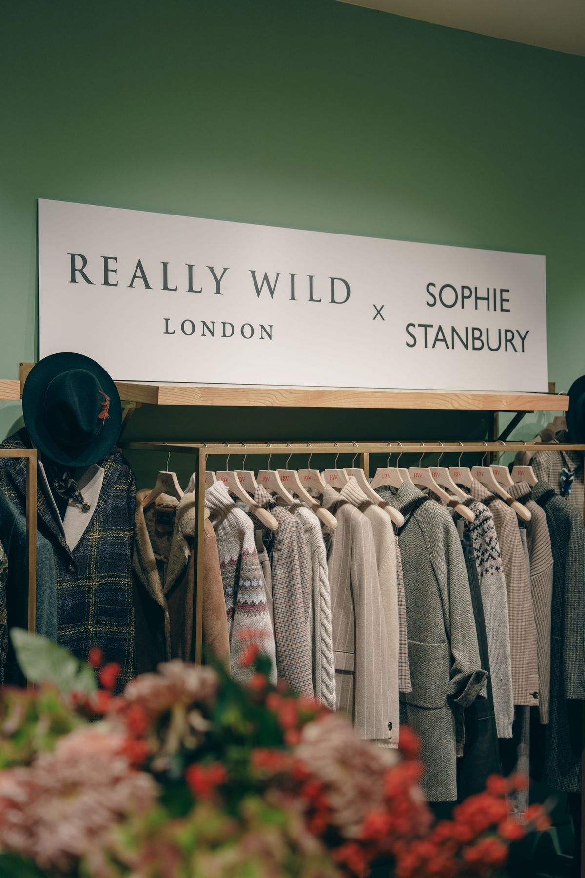 Really Wild London x Sophie Stanbury sign above a rail of knitwear in the Sloane Square shop, by REGO Creative