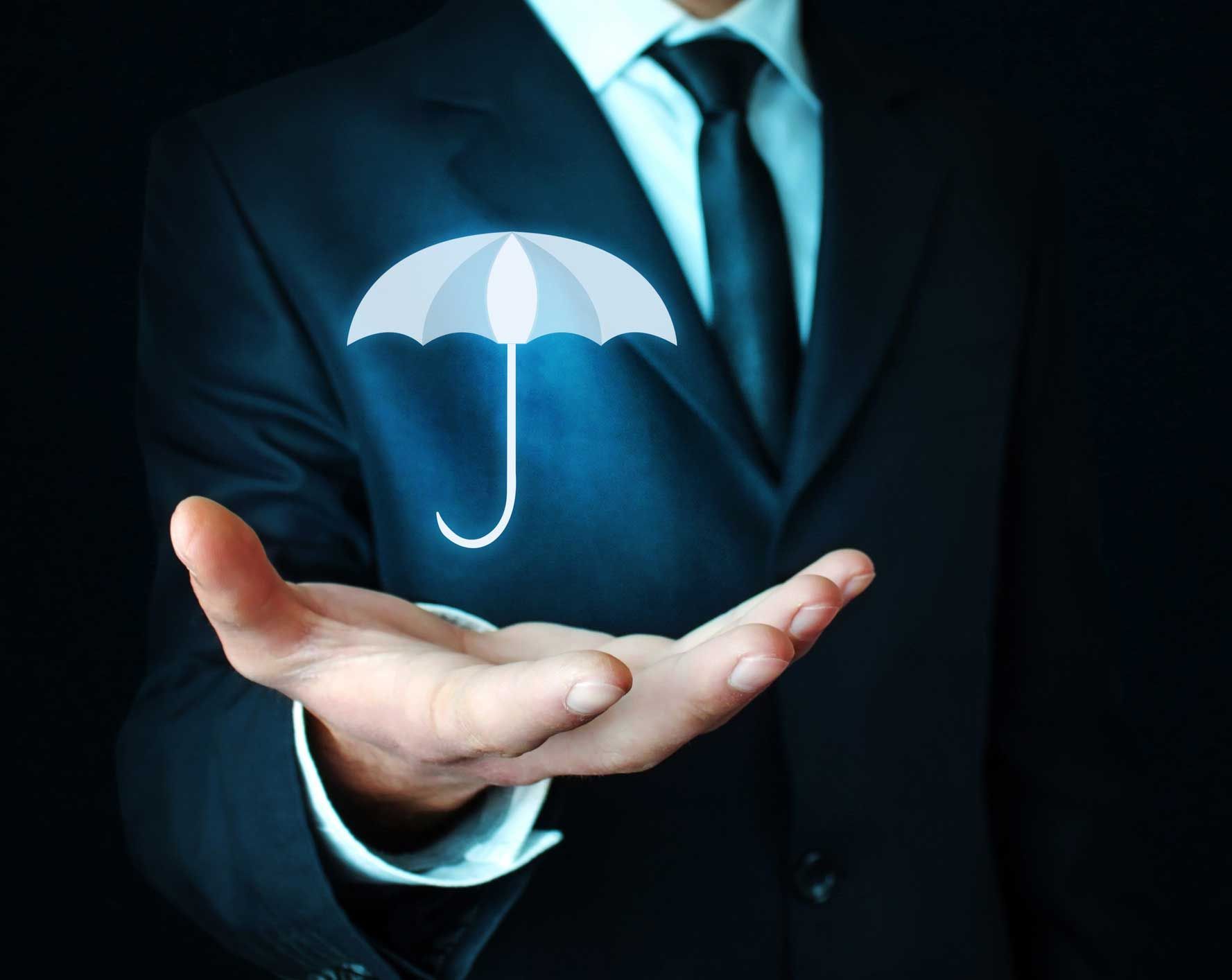 A man in a suit is holding an umbrella in his hand