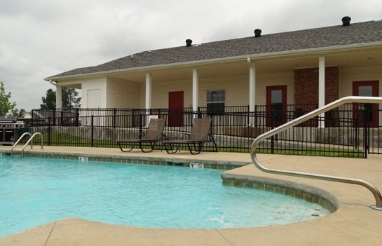 A large swimming pool in front of a house
