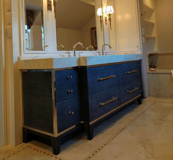A bathroom with two sinks and a mirror