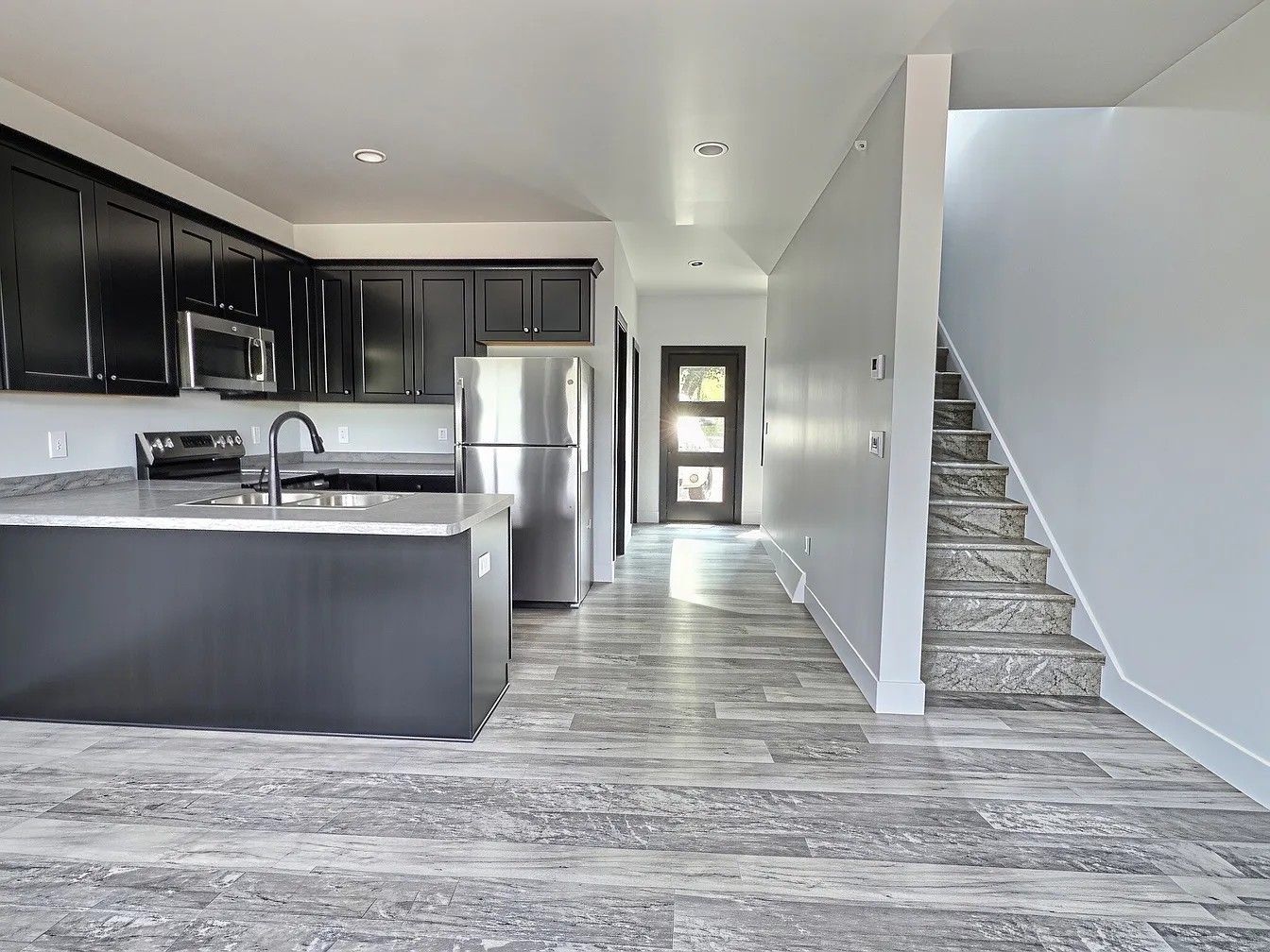 Updated kitchen with contemporary cabinetry and stainless appliances