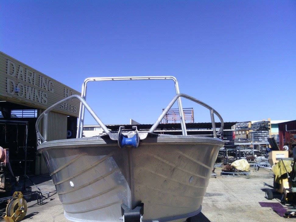 A Boat Is Sitting In Front Of A Building That Says Parking Industries — DJ Welding & Services in Currajong, QLD