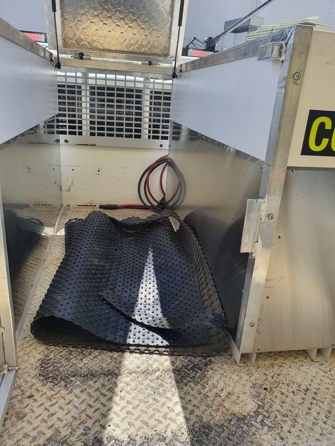 A Black Mat Is Laying On The Floor Of A Metal Cage — DJ Welding & Services in Currajong, QLD 