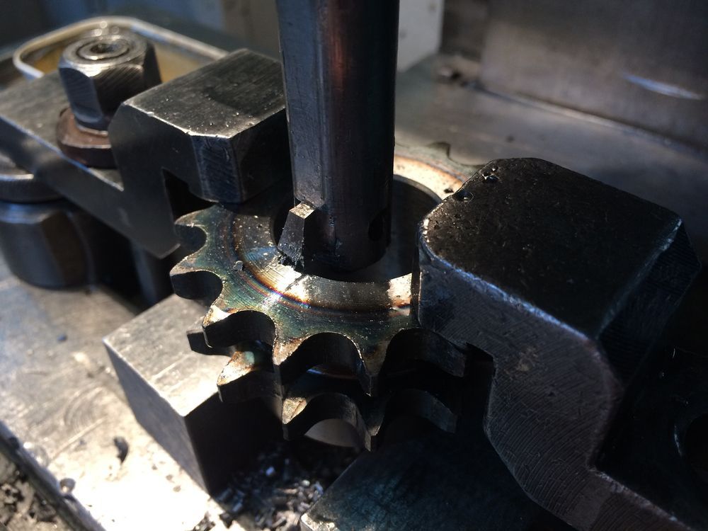 A Bunch Of Metal Pieces With Holes In Them Are Sitting On A Table — DJ Welding & Services in Currajong, QLD 