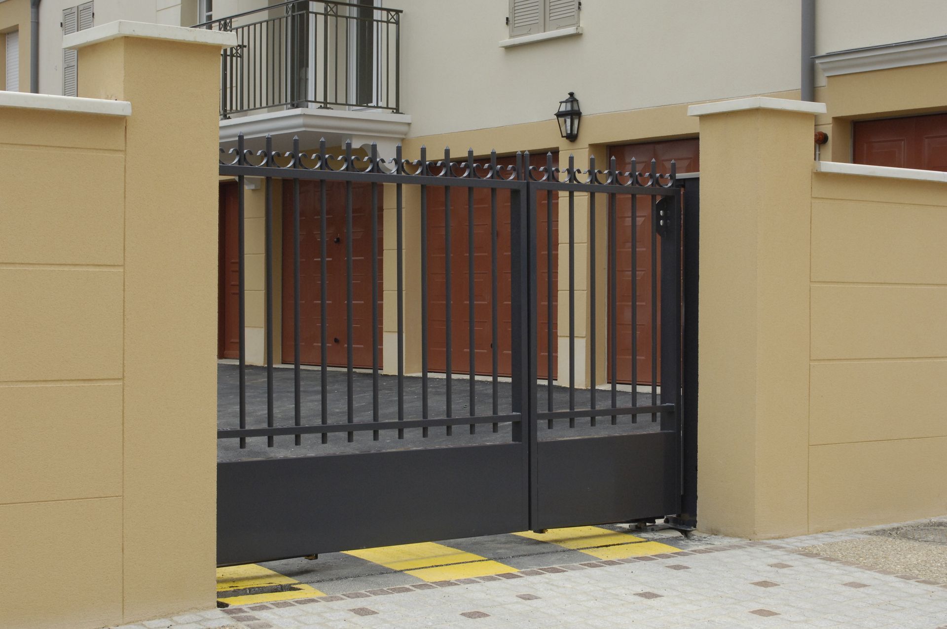 Closed metal gates and cream wall