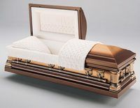 a brown metal coffin with the lid open and a white blanket .