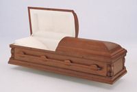 a wooden casket with the lid open on a white surface .
