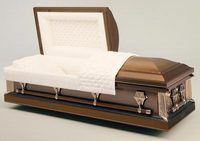 a brown metal coffin with the lid open and a white blanket .
