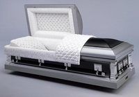 a wooden coffin with the lid open is sitting on a table .