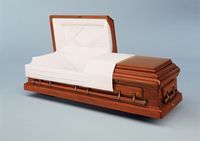 a wooden casket with the lid open is sitting on a table .