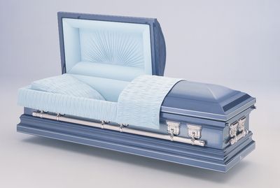 a wooden coffin with the lid open is sitting on a table .