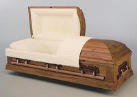a wooden casket with the lid open on a white surface .