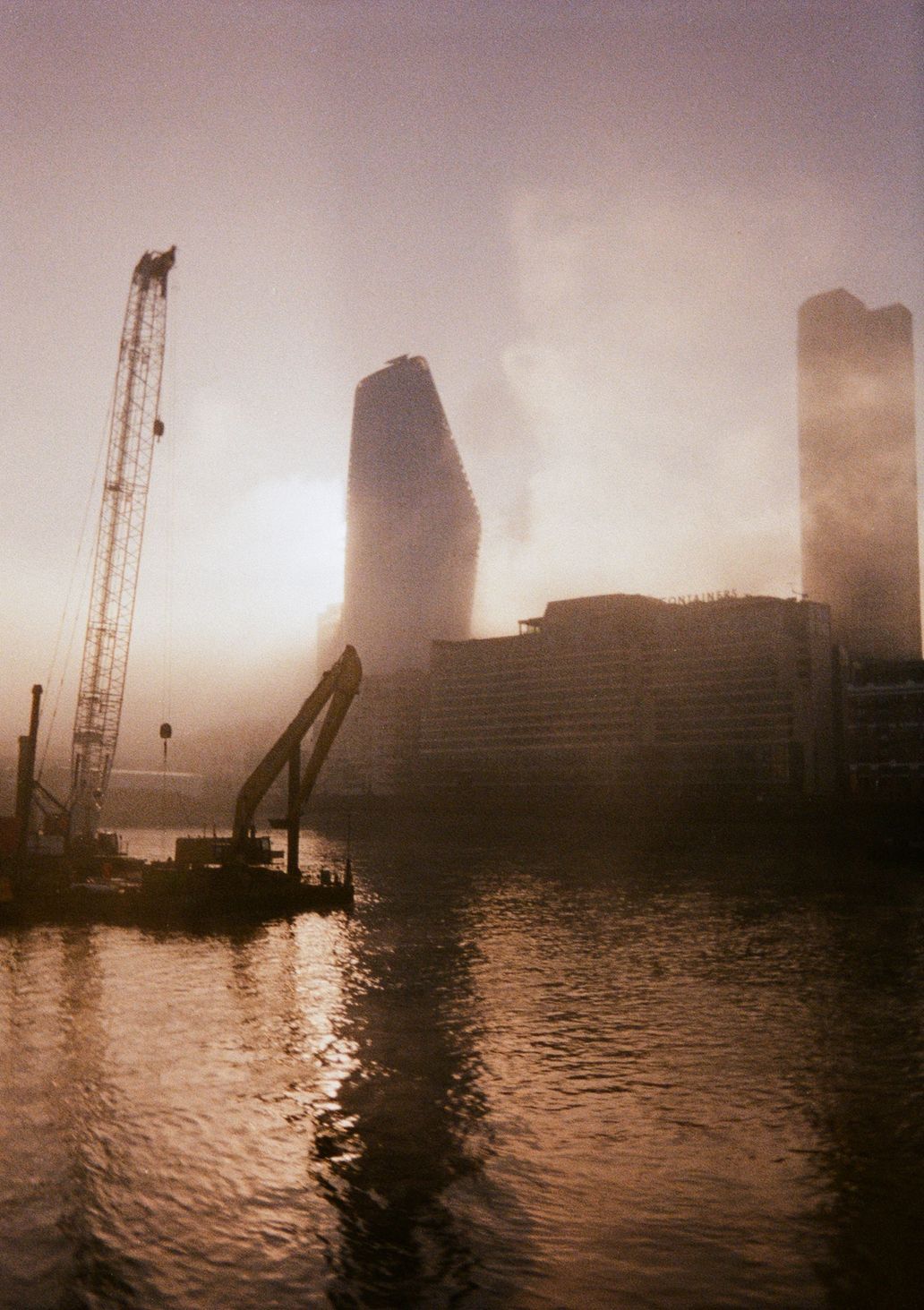 misty view of buildings near the thames black and white photo