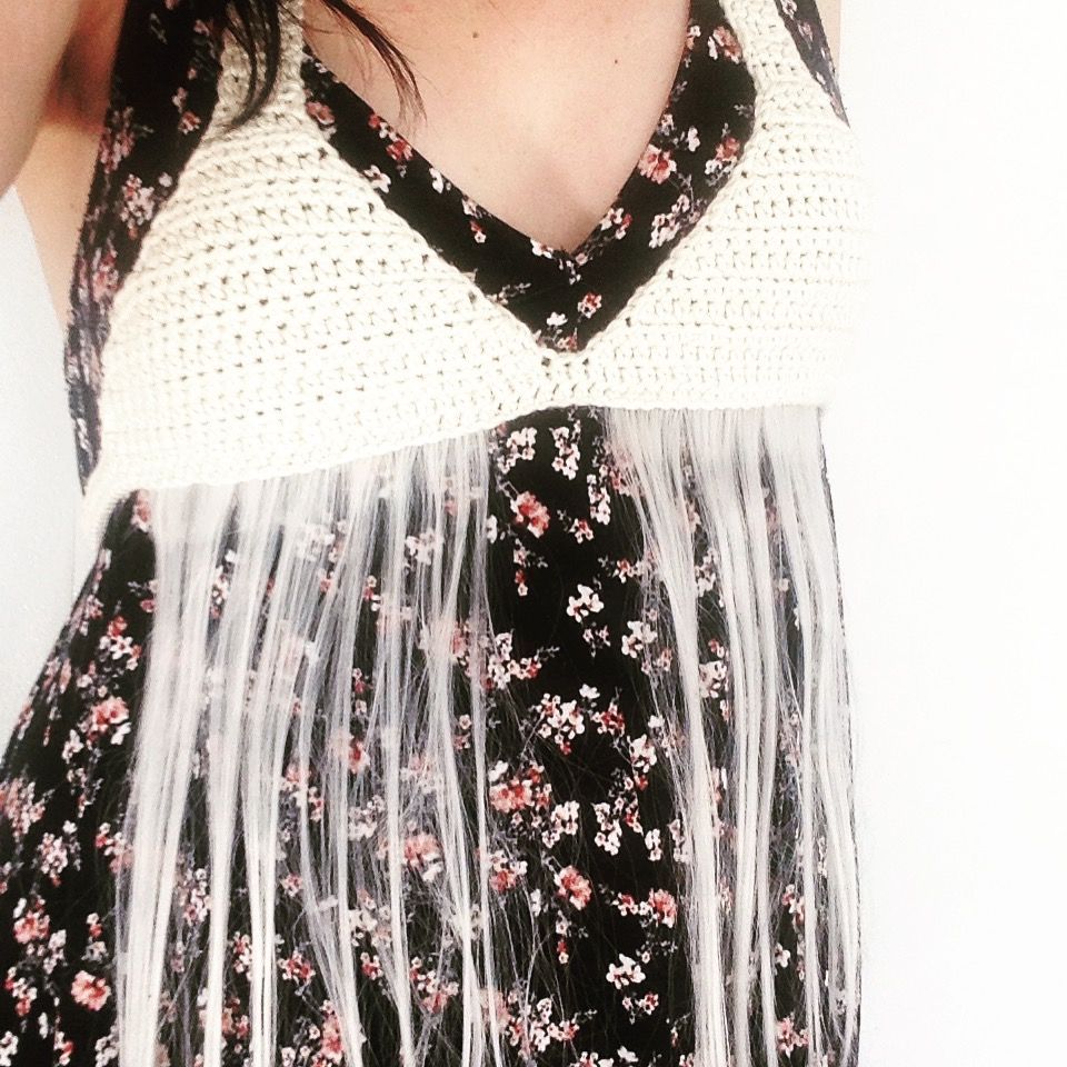 crochet white bikini top with fake hair attached like tassels on a person in a floral dress
