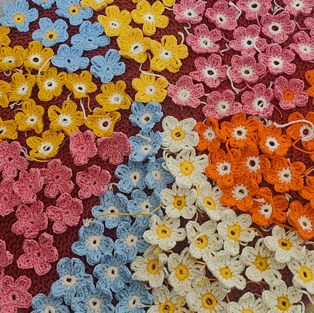 lots of small colourful crochet flowers
