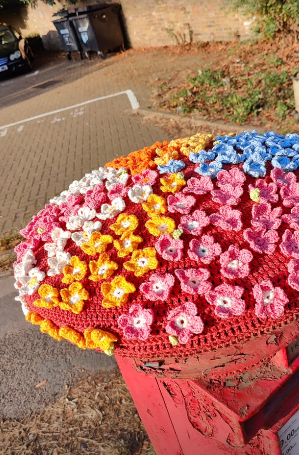 colourful crochet flowers on a postbox topper, Iver  Hight Street