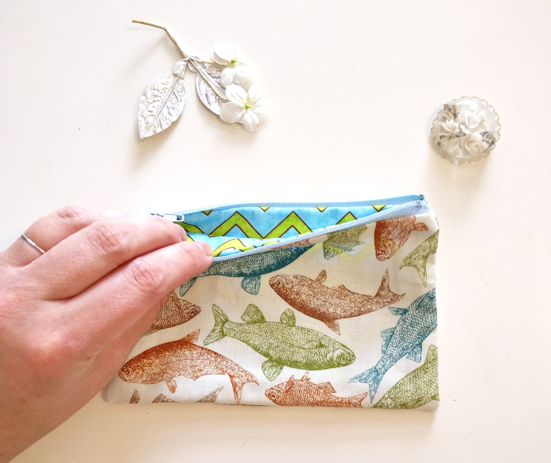 hand revealing zigzag pattern inside fish fabric purse