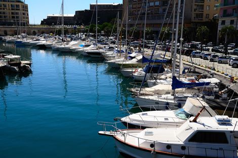 Boats docked in a harbor with blue water and buildings in the background. Sunny day. | Gainesville Marine Repair