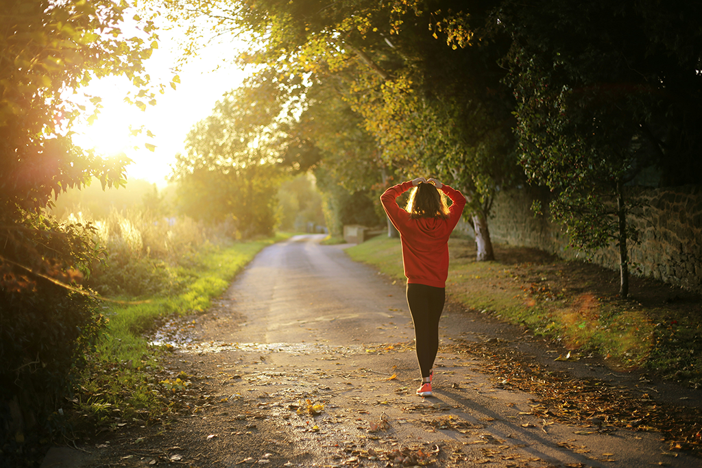 Woman walking in the sunrise
