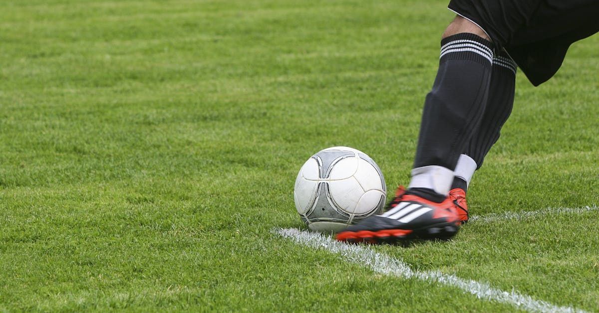 Feet kicking a football