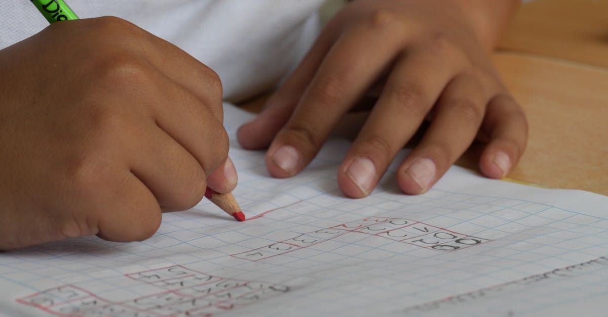 Close up of child's hands doing homework