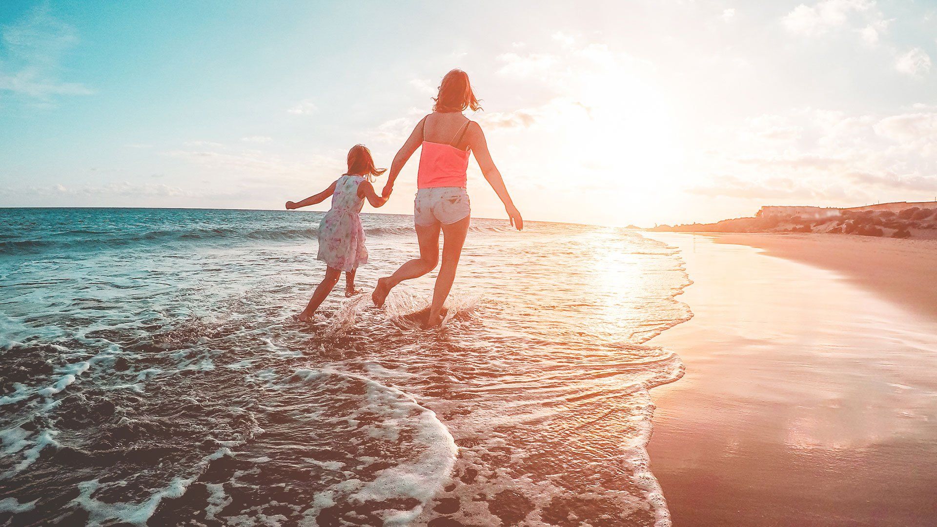 Mother and Daughter Running Inside the Water on Tropical Beach — Forest Lake QLD — yourvisa4australia