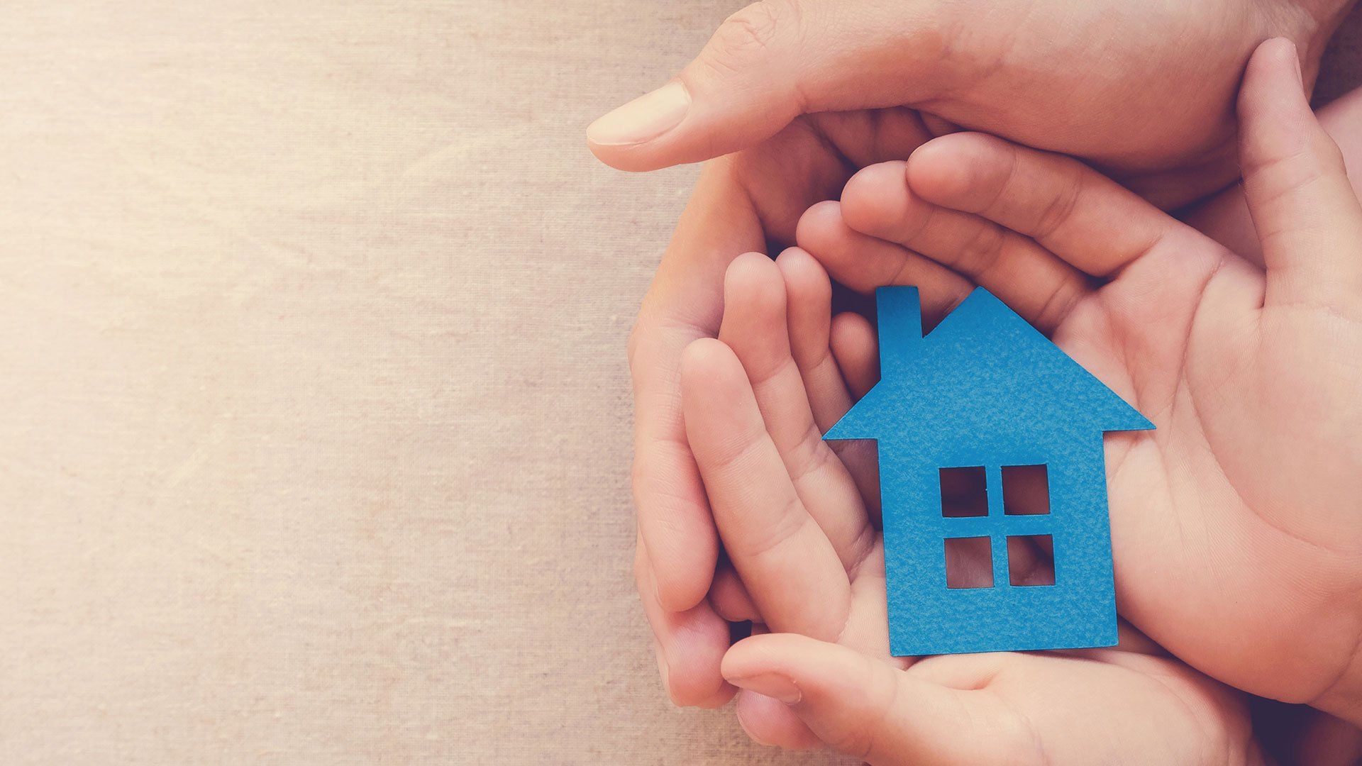 Adult and Child Hands Holding Blue Paper House for Family Home — Forest Lake QLD — yourvisa4australia