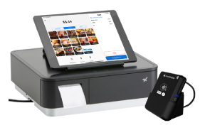 Tablet POS terminal with touchscreen on a gray kiosk and a small card reader beside it