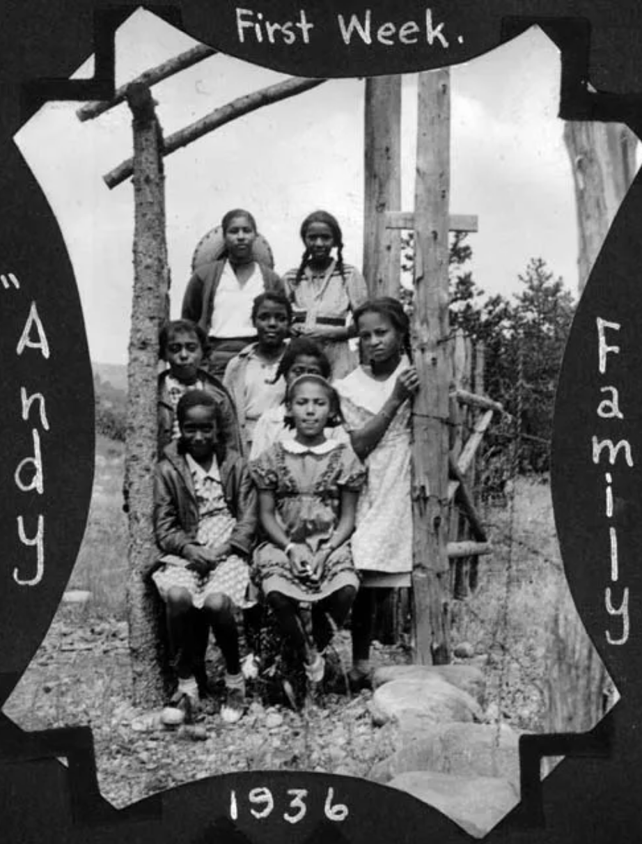 A black and white photo of a group of children taken in 1936