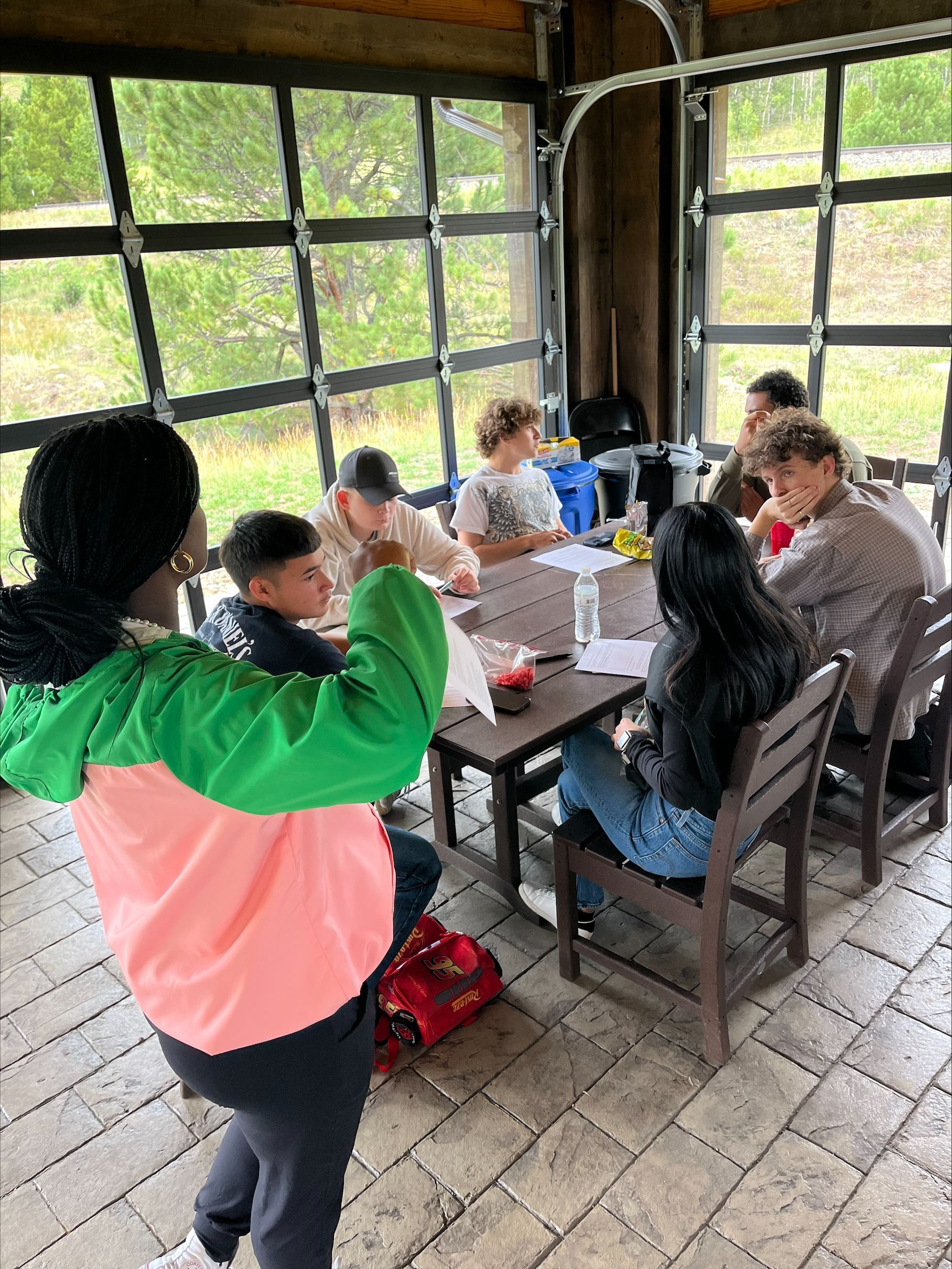 A group of people are looking at fish in a pond.
