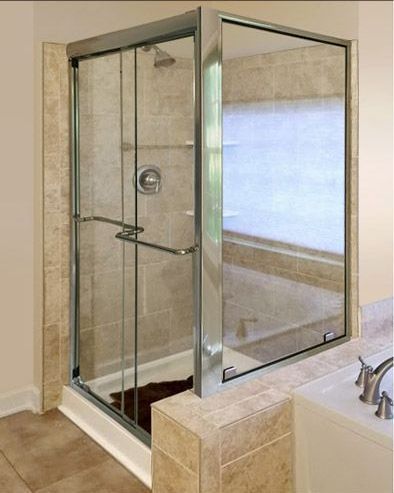 Glass walk-in shower with chrome fixtures and beige tile in a bathroom