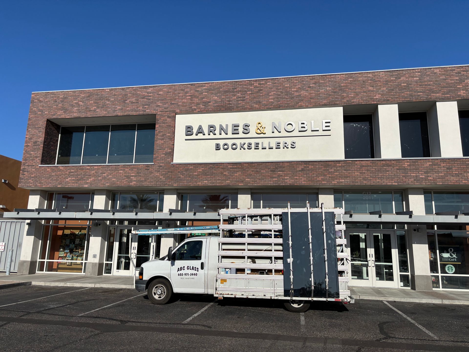 White delivery truck parked in front of a Barnes & Noble bookstore.