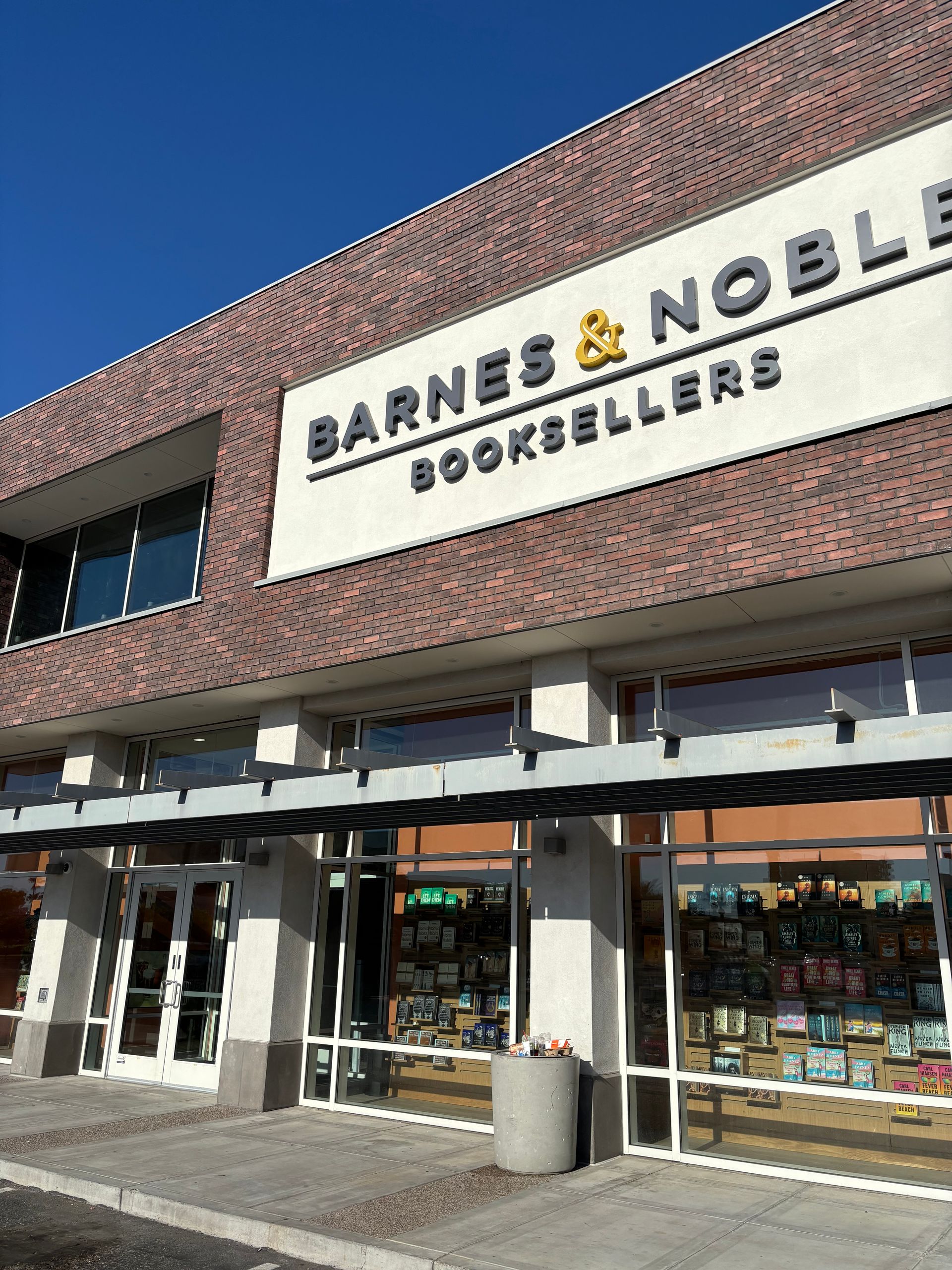 Barnes & Noble bookstore exterior; red brick, large signage, glass windows showing books inside.