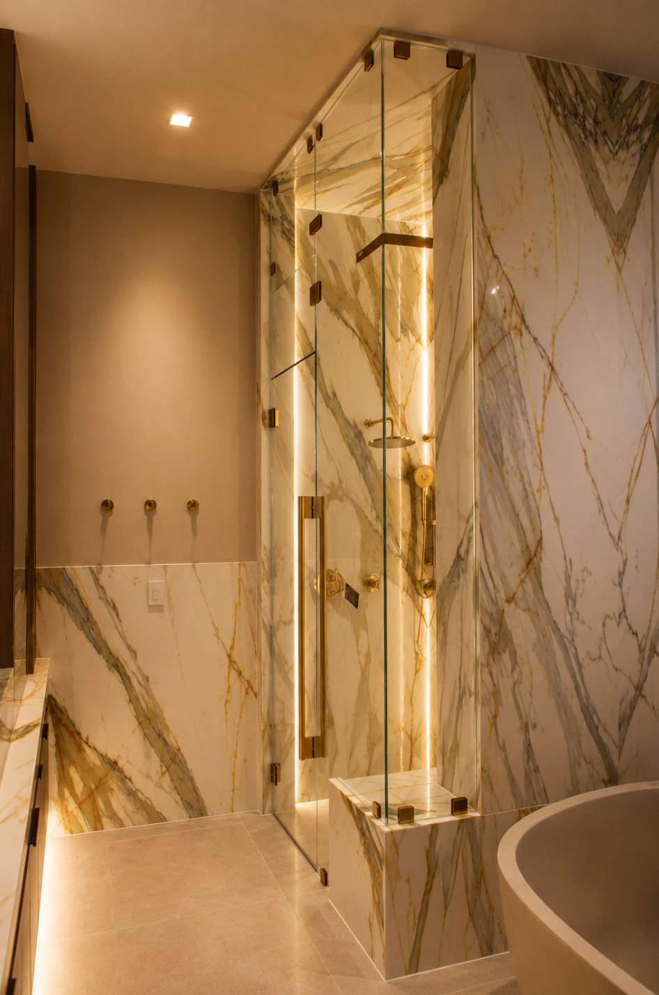 Modern marble bathroom with walk-in shower, warm lighting, and a freestanding tub
