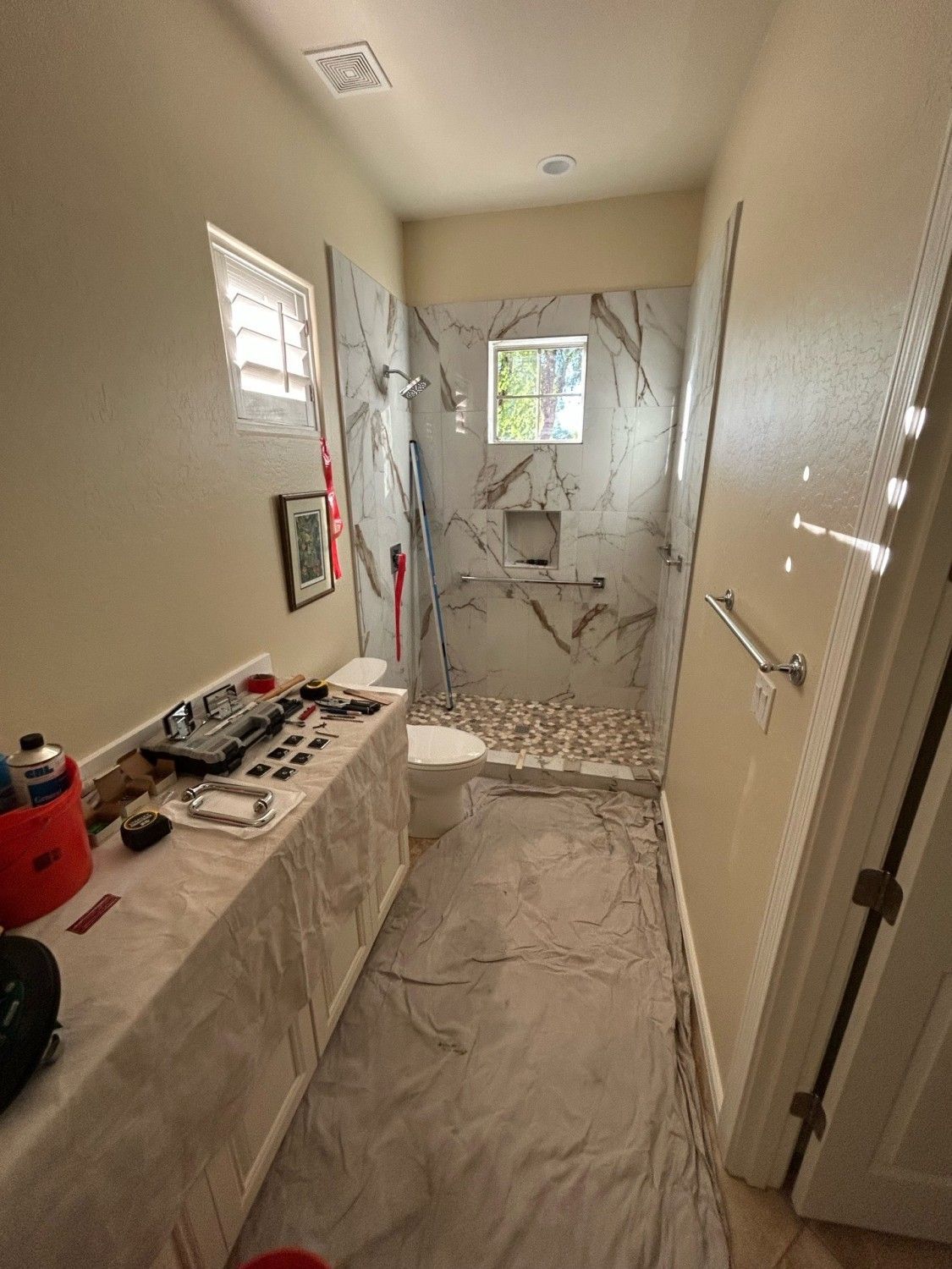 Technician preparing a frameless shower enclosure