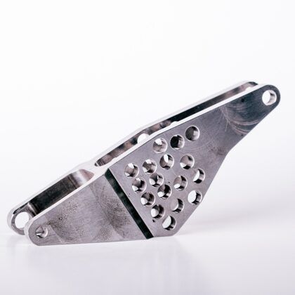 Silver-colored metal bracket with multiple holes, angled and lying against a white backdrop.