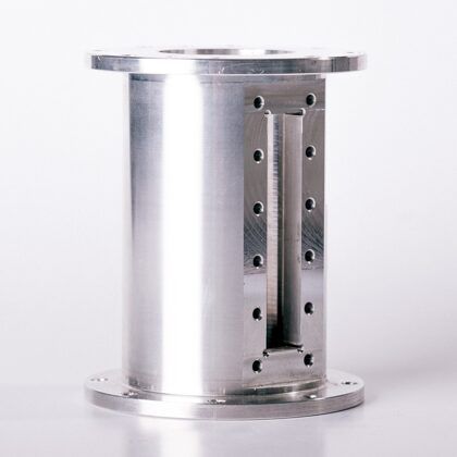 Cylindrical metal device with two flanges and a rectangular slot, possibly for industrial use.