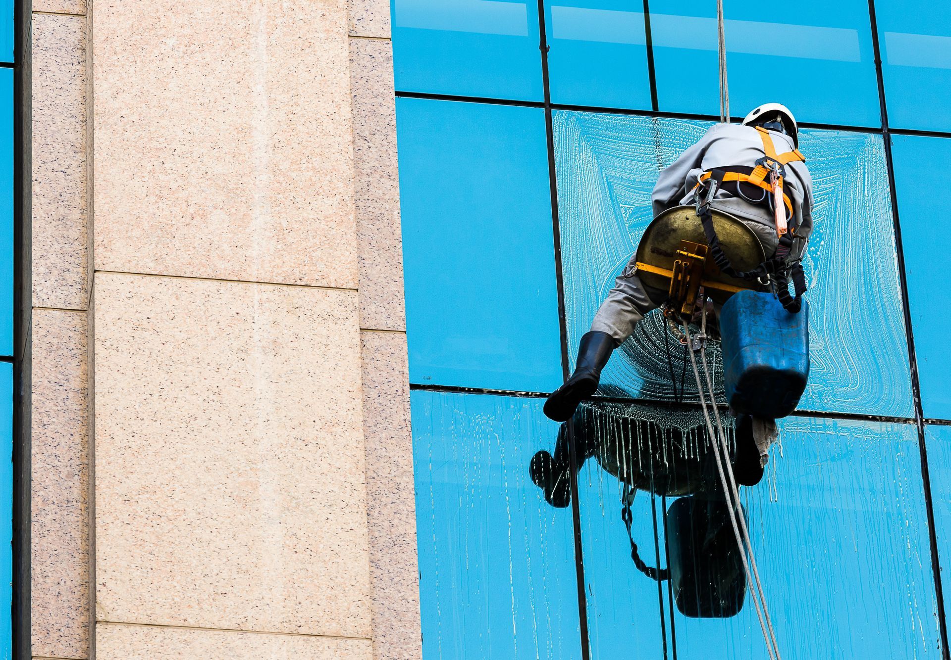 man fixing commercial building window