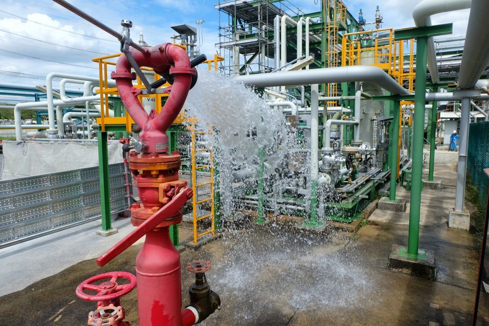 Red Fire Hydrant Spraying Water at Industrial Facility — Industry Fire Services in Brisbane, QLD