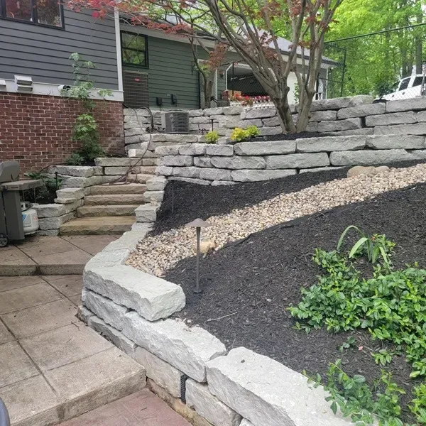 stone patio, walk way and steps with multi-level flower beds in Zionsville