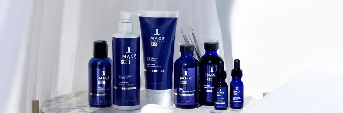A group of blue bottles and tubes of cosmetics are sitting on a table.