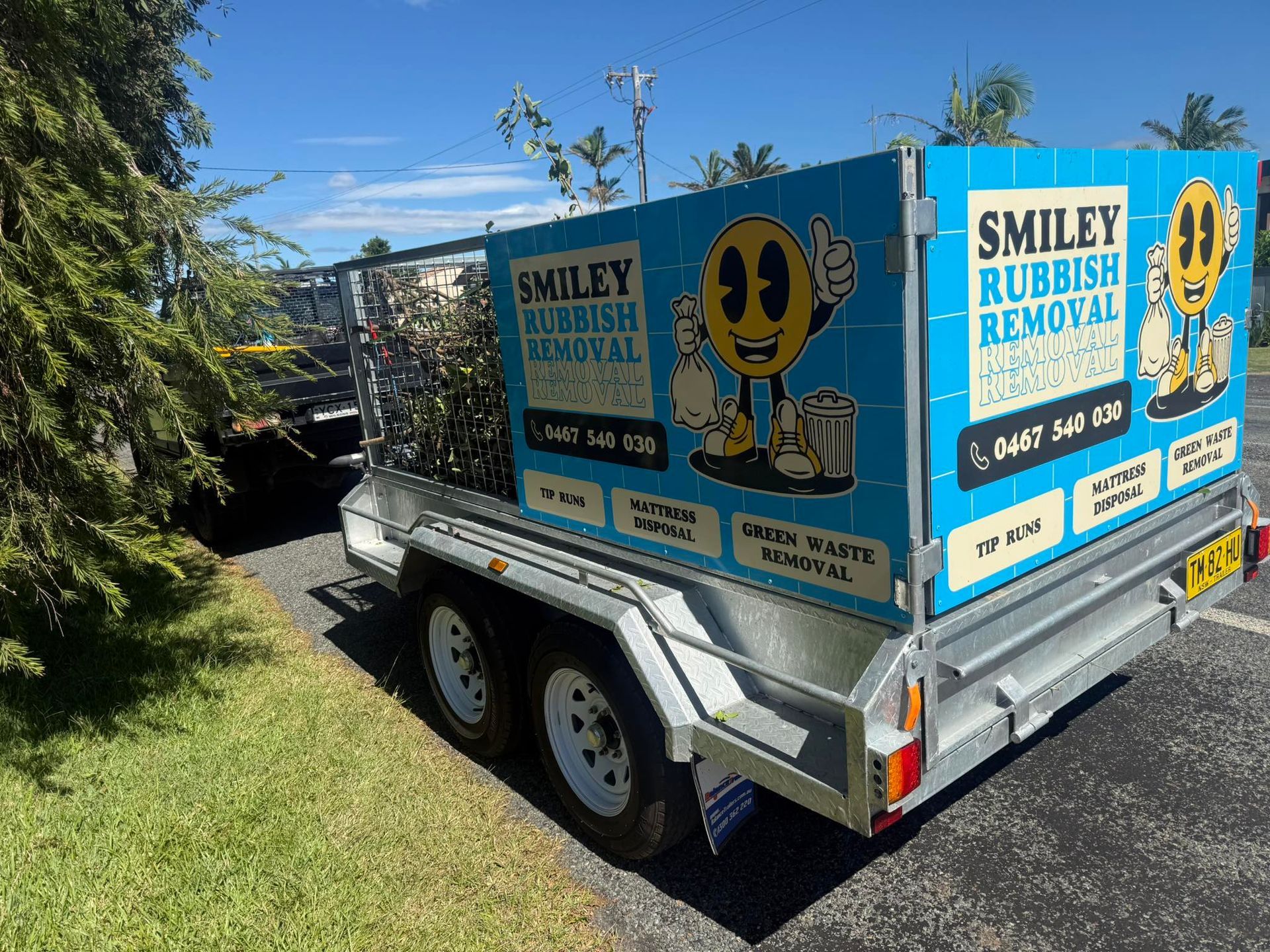 A Blue Smiley Rubbish Removal Utility Trailer Parked Outdoors — Smiley Rubbish Removal In Wauchope, NSW