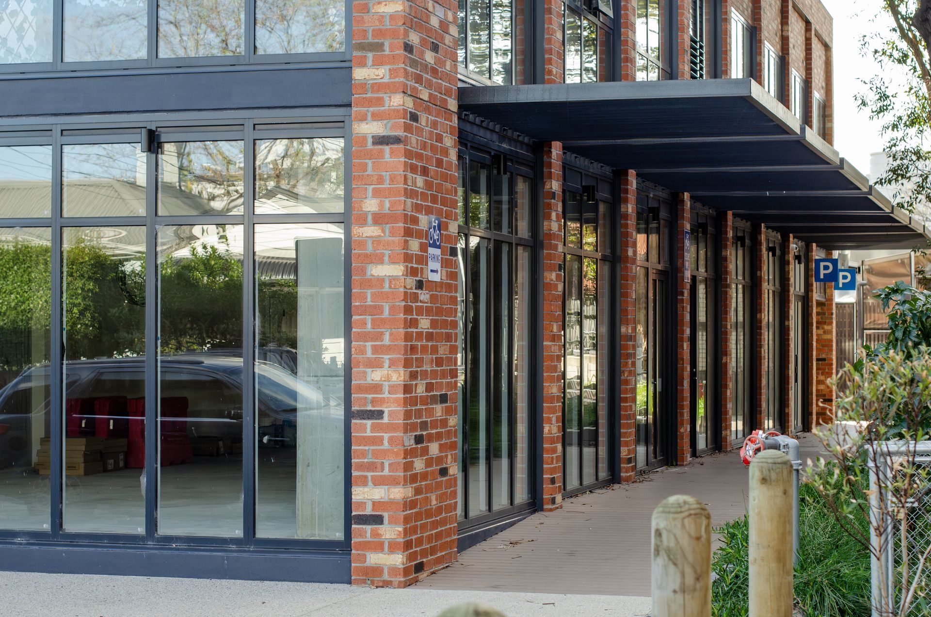 An empty corner retail unit with glass frontage.