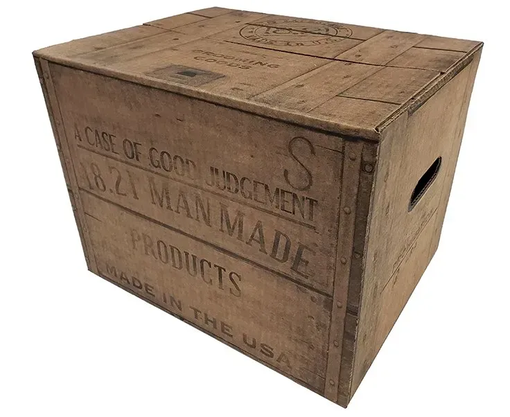 Wooden crate stenciled “Made in U.S.A.” with side handle openings, viewed at an angle.