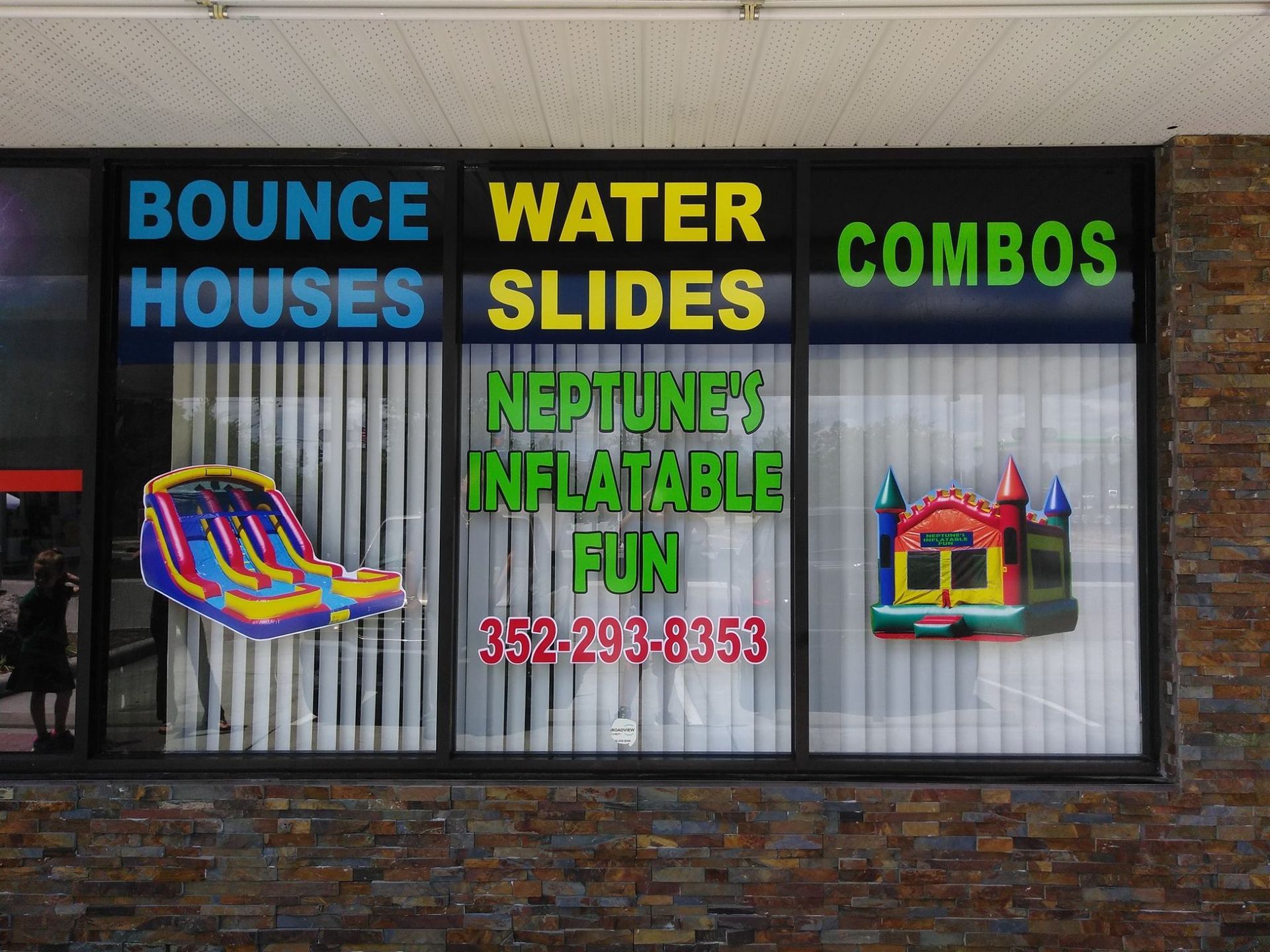 A window display for bounce houses water slides and combos