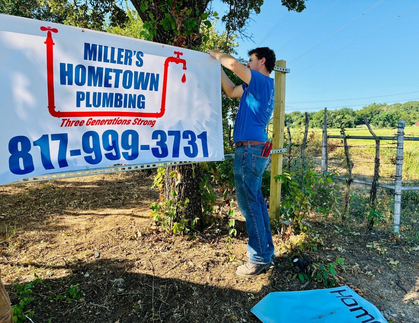 Man hangs a banner for 