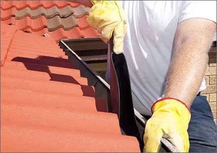 roofer cleaning gutters